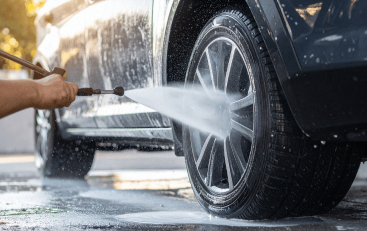 Pressure washing vehicle wheel during exterior car detailing process